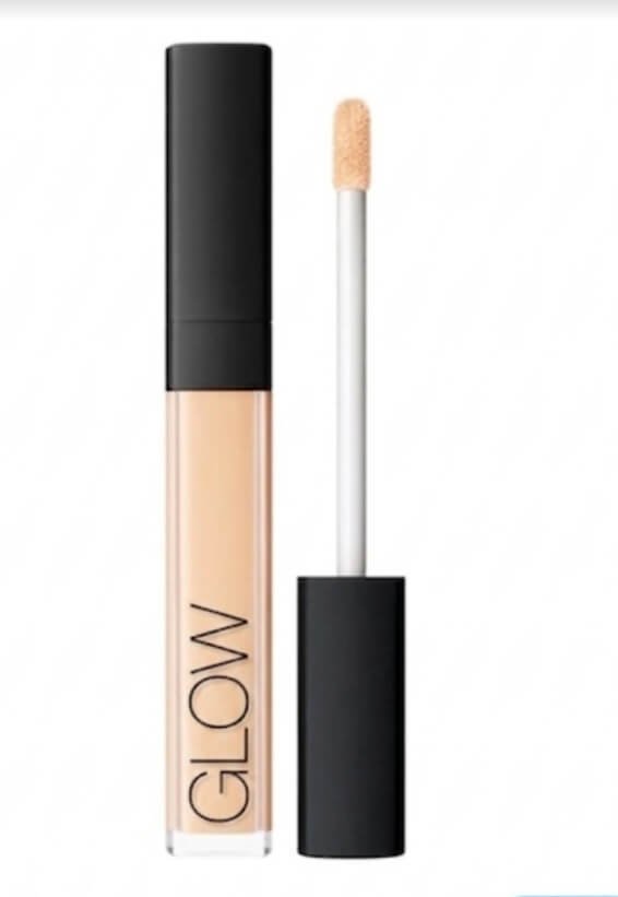 "Glow liquid beauty product.Concealer with an open applicator brush"